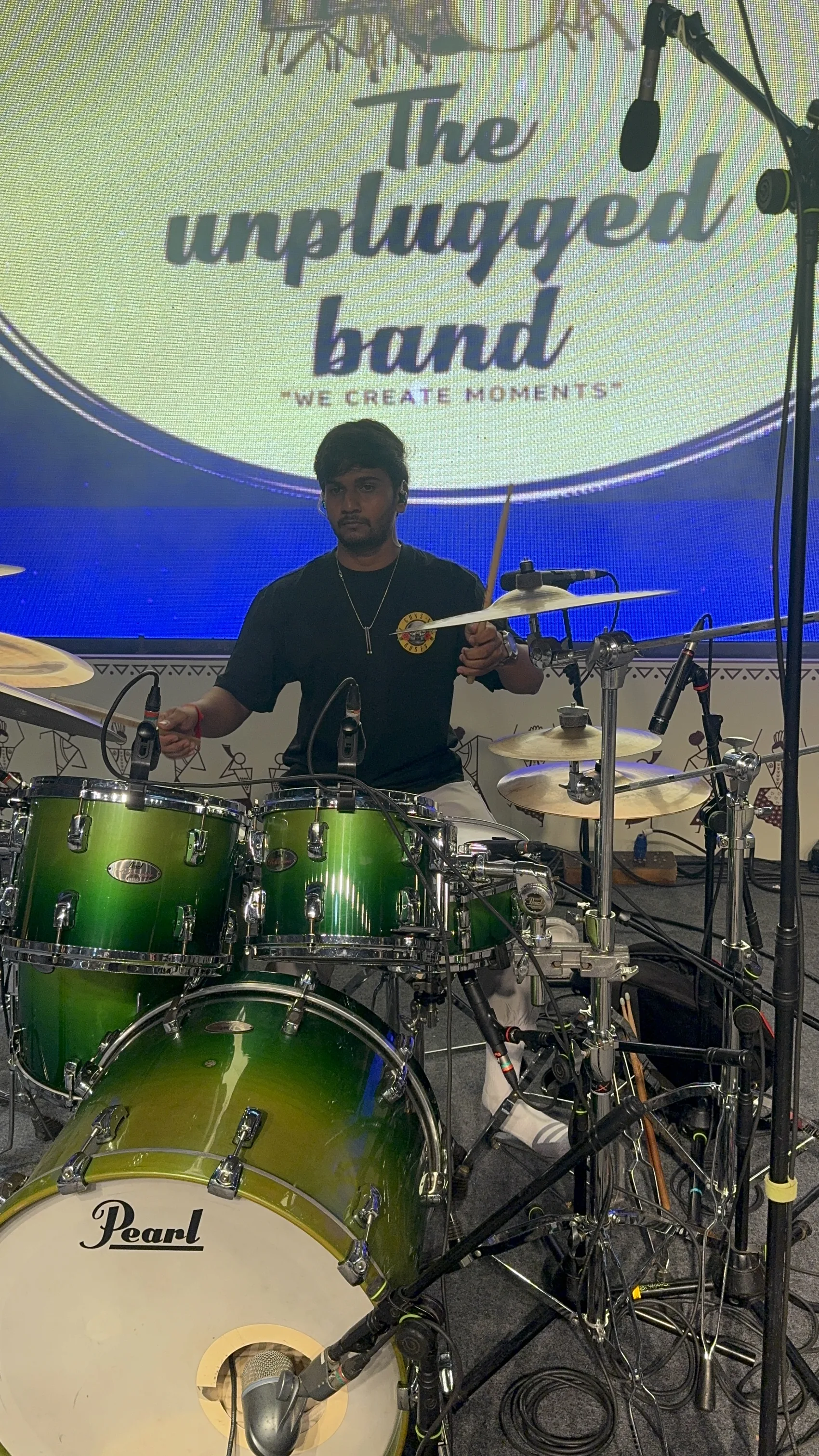 Kunjan Patel behind the kit, band backdrop up